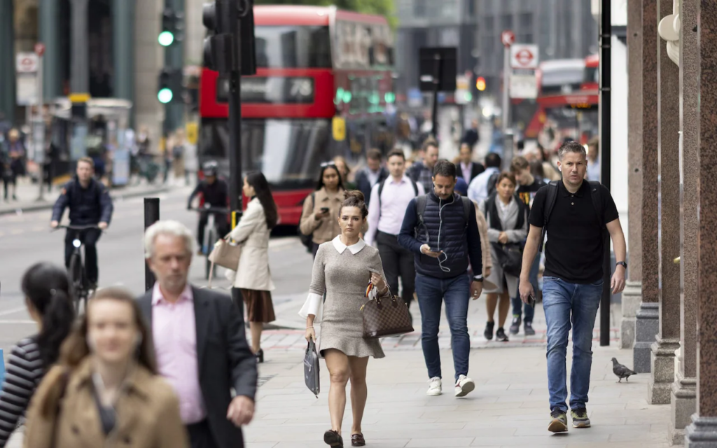 image of people walking outside on a busy street