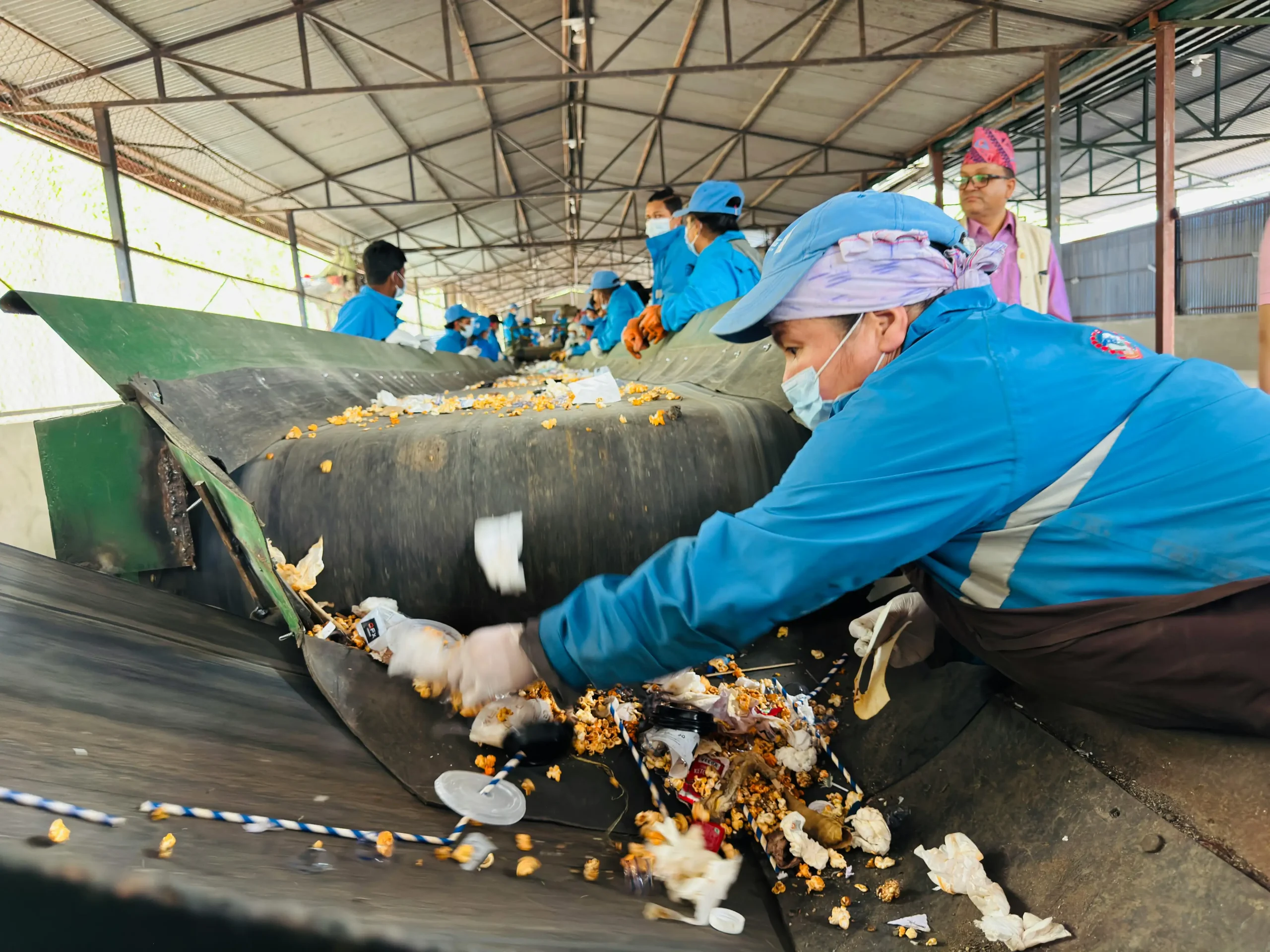 Waste management coordinator organizing environmental compliance documents and disposal schedules