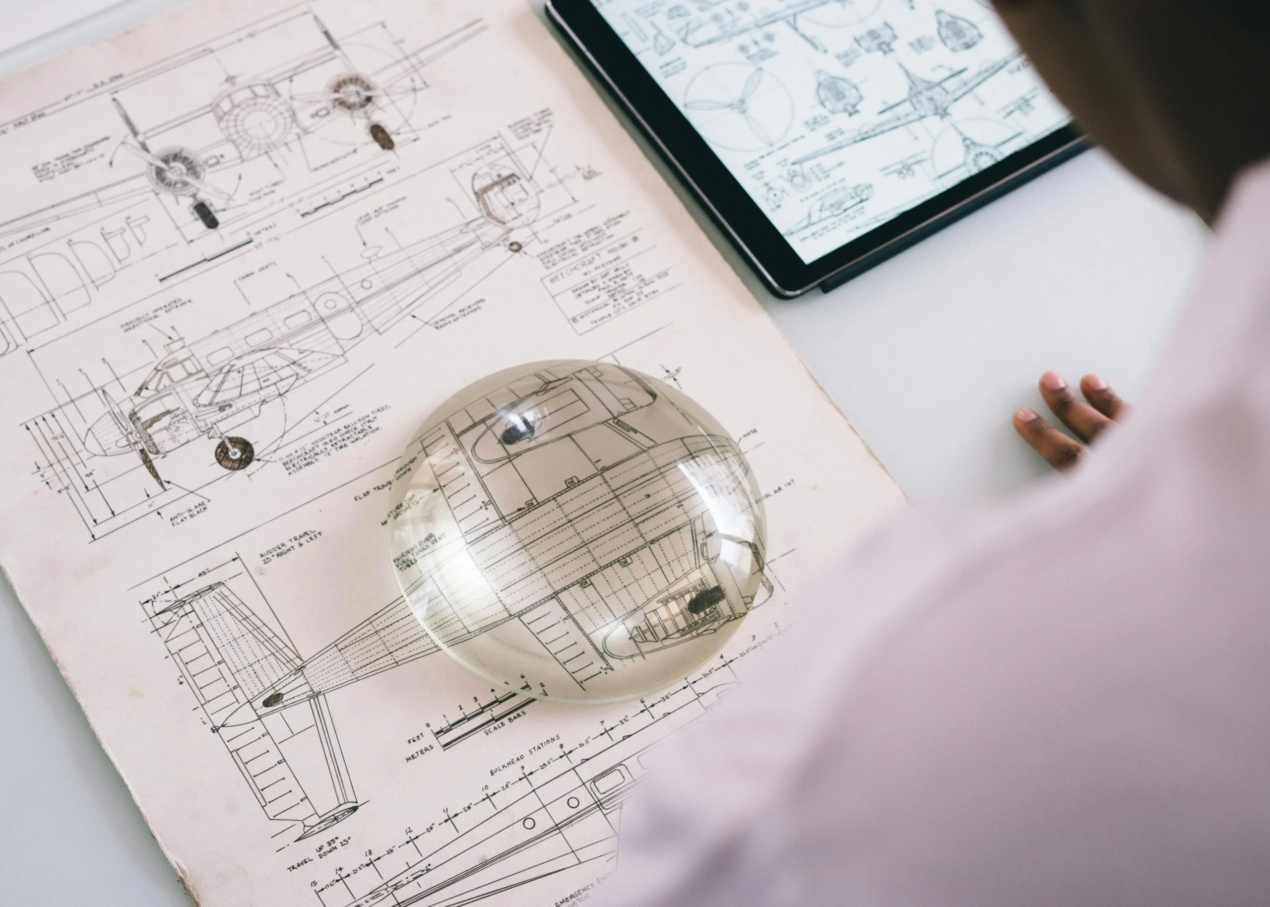 Engineering blueprint and magnifying glass
