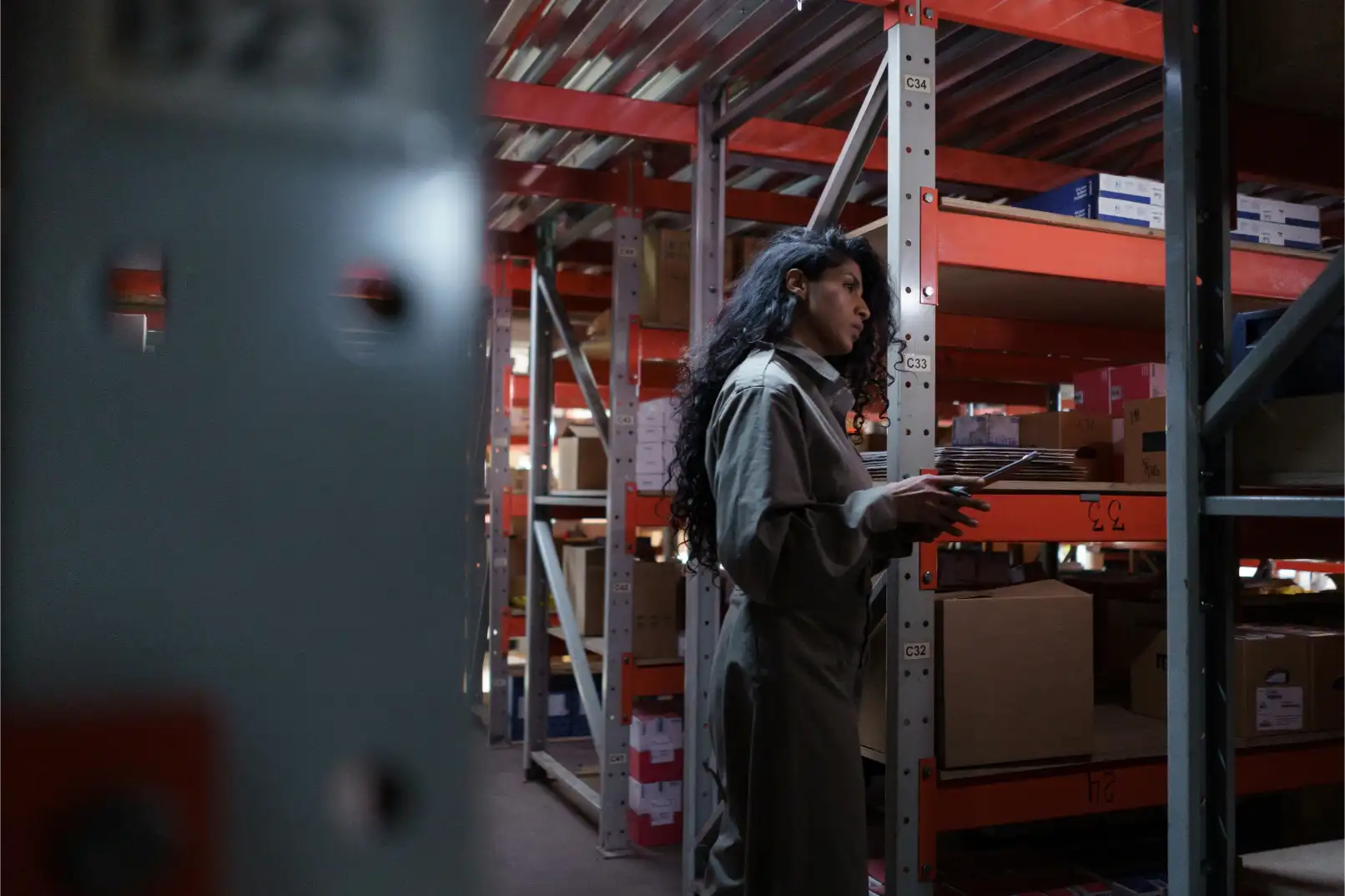 Supply chain analyst reviewing logistics data and tracking manufacturing inventory
