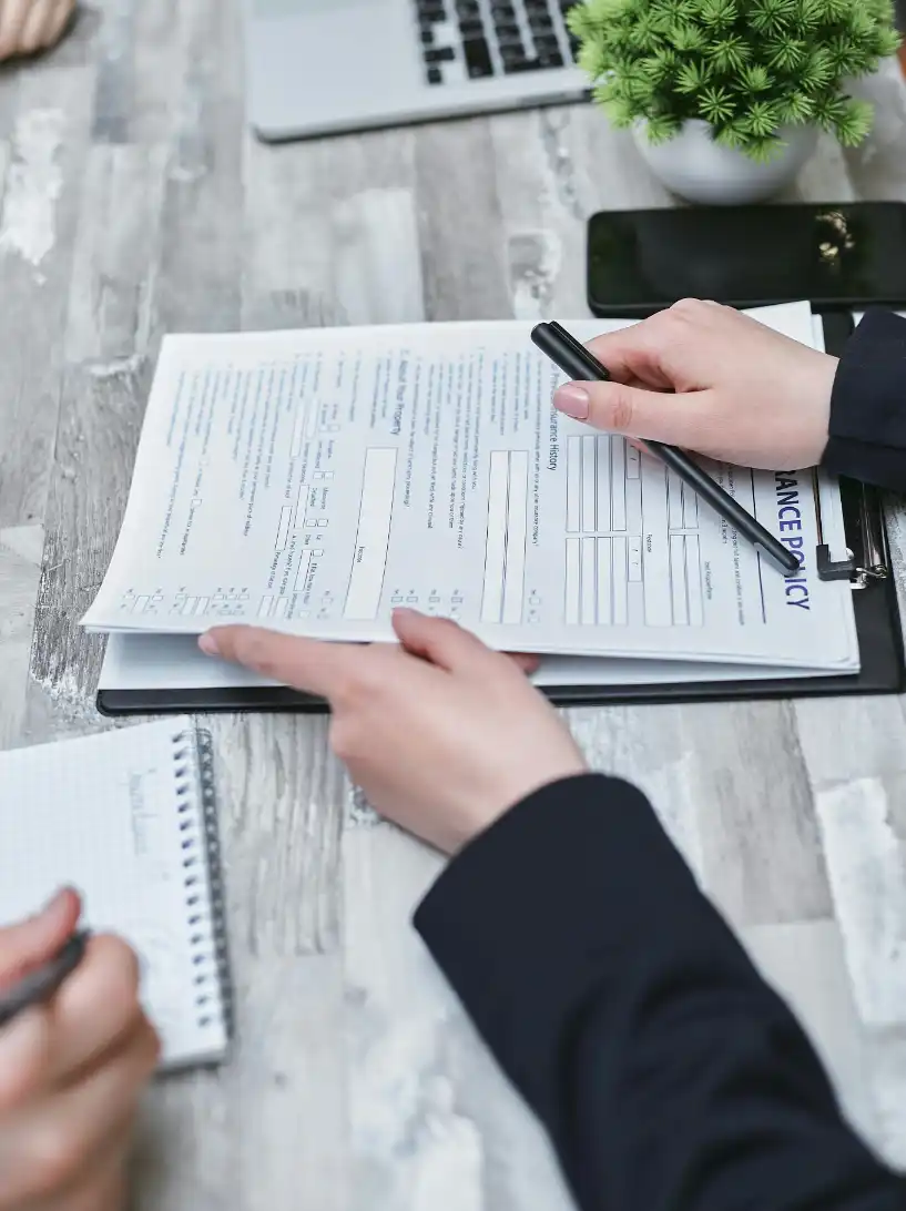 Insurance compliance analyst reviewing policies and regulatory documentation