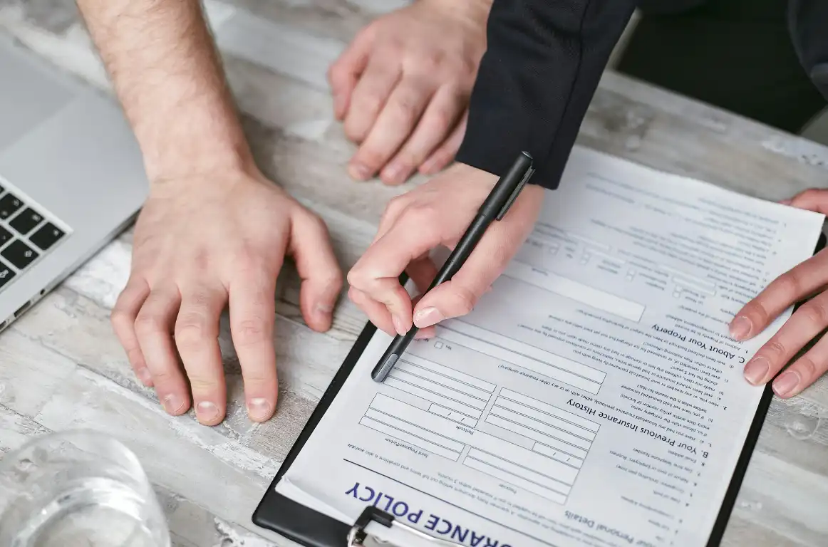 Insurance policy processing officer reviewing documents and updating systems