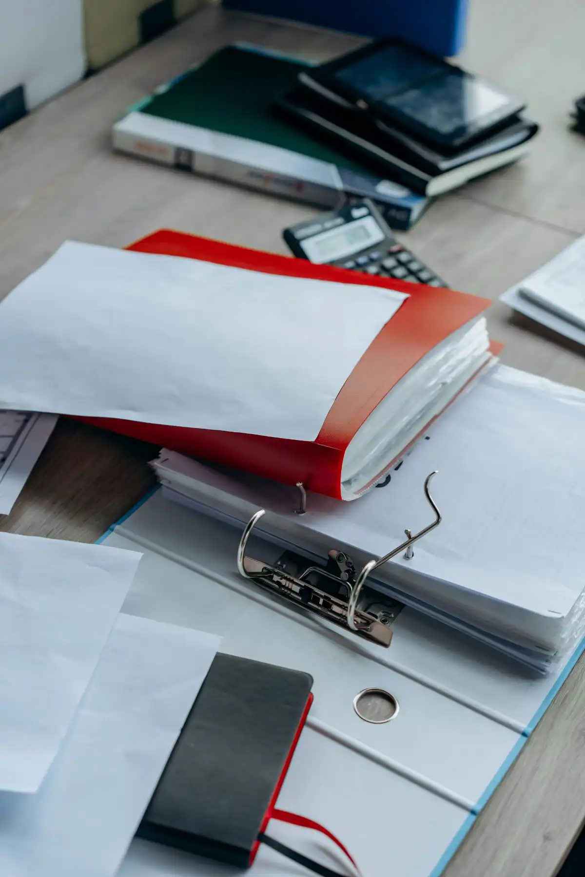 Regulatory Compliance Officer reviewing insurance documentation and audit files