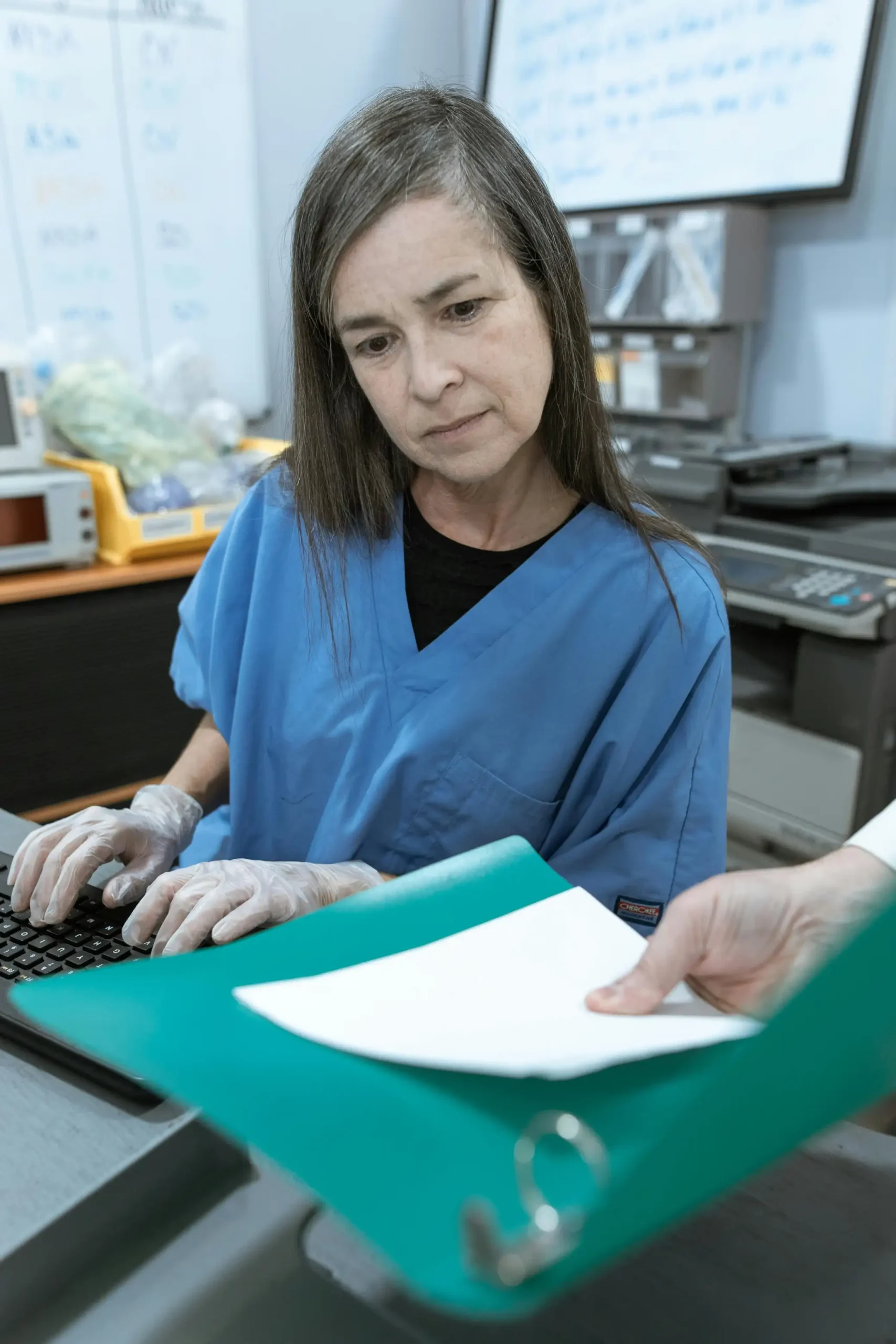 Clinical administrator organizing patient records and healthcare documentation