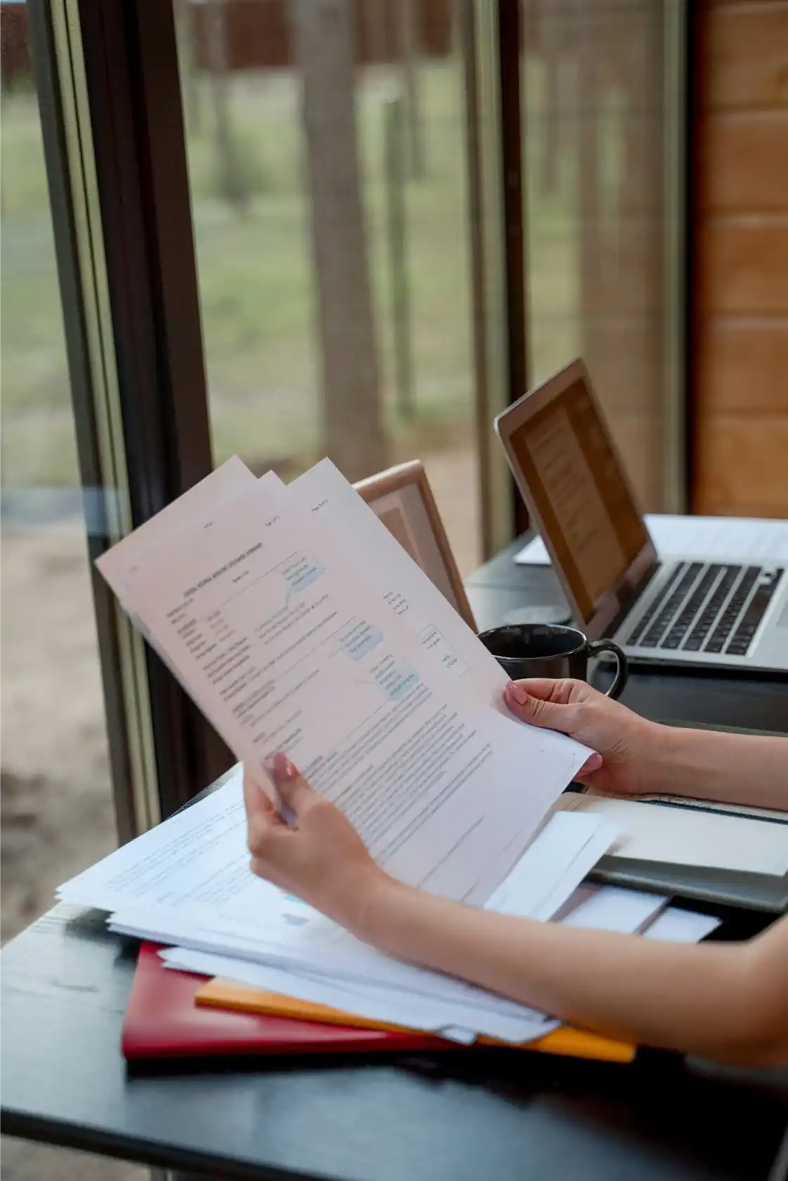 Claims Examiner reviewing insurance files and documents